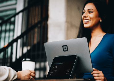 Person at a counter serving coffee