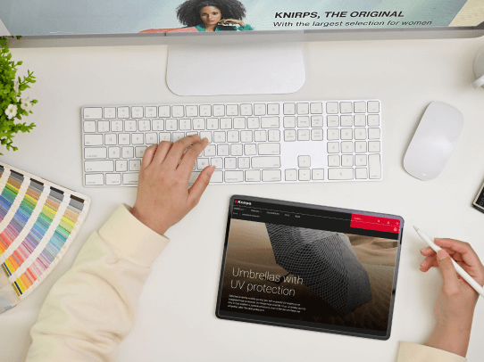 Top view of person working on a desktop and a tablet
